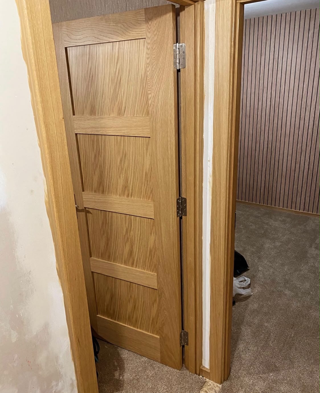 Oak door hung on new lining with brass hinges